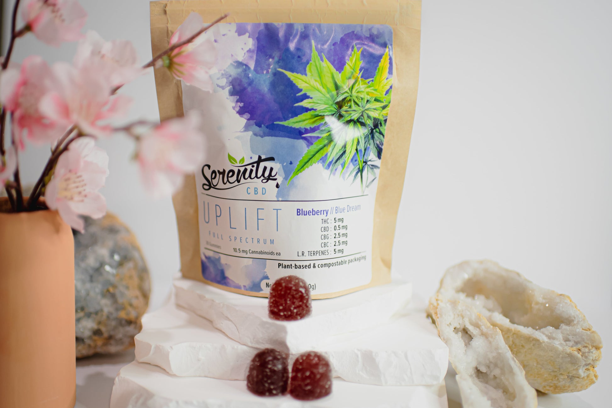 Serenity CBD ‘Restore’ full spectrum gummies pouch with cherry blossoms, crystals, and red gummies—evoking balance, relaxation, and holistic plant-based wellness
