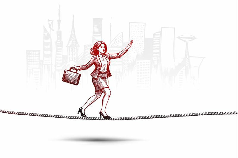 Businesswoman walking a tightrope above a city skyline