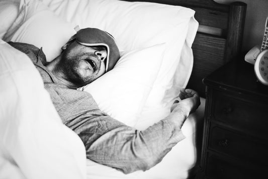man pictured in a black and white photo of him deep in REM sleep