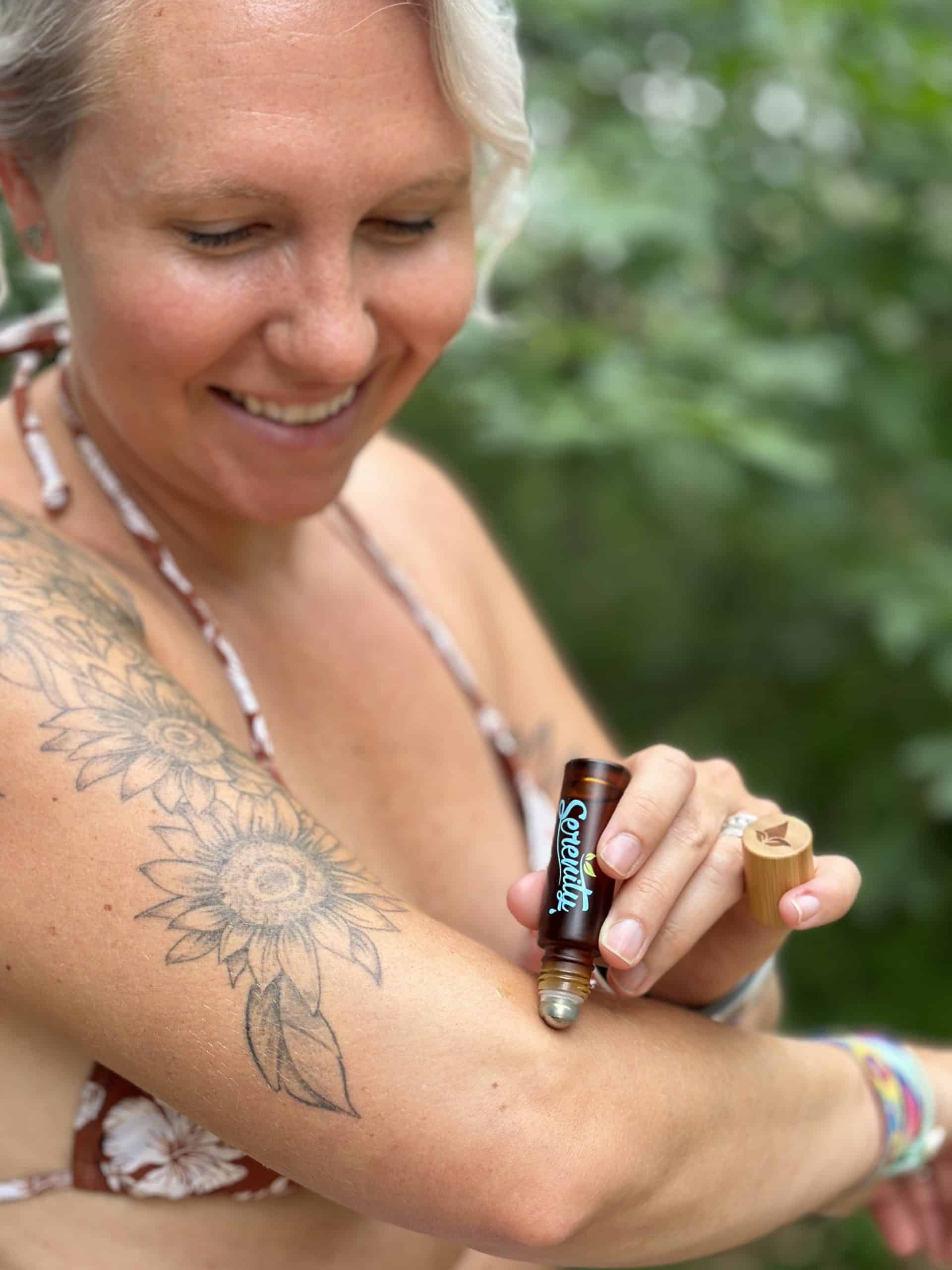 A woman applying Serenity CBD’s Classic Roller on her arm - Organic, full-spectrum CBD roll-on for quick relief and muscle relaxation.