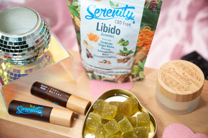 Serenity CBD products including gummies, tinctures, and a jar on a wooden surface.