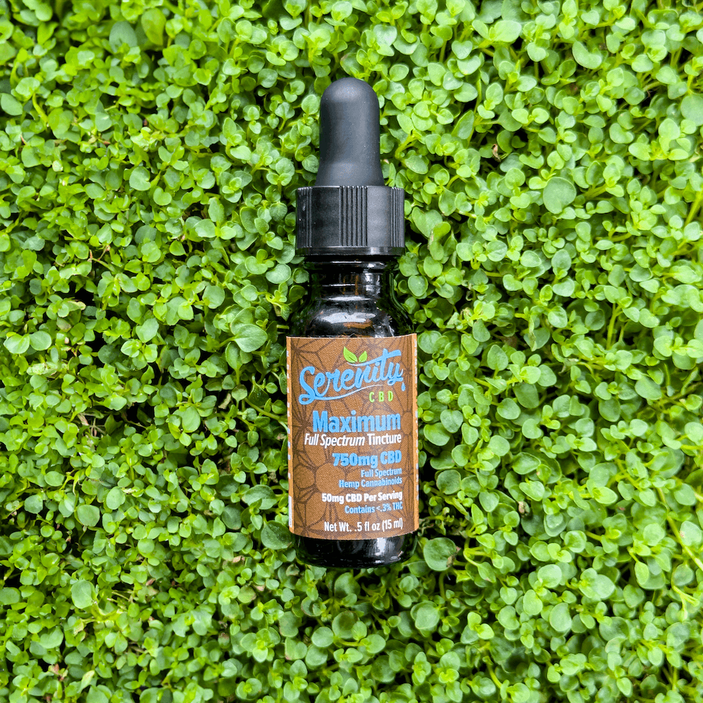 Pair of Serenity CBD Maximum 3000mg Oil Tincture bottles placed on green grass—emphasizing strength, balance, and nature-based care