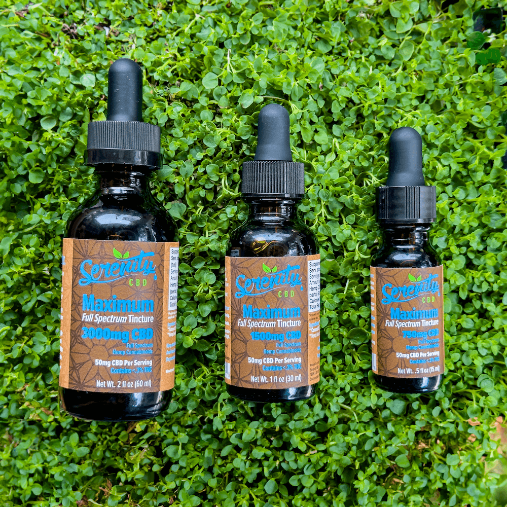 Serenity CBD Maximum 3000mg Oil Tinctures displayed on fresh green grass—symbolizing plant-powered wellness and natural relief