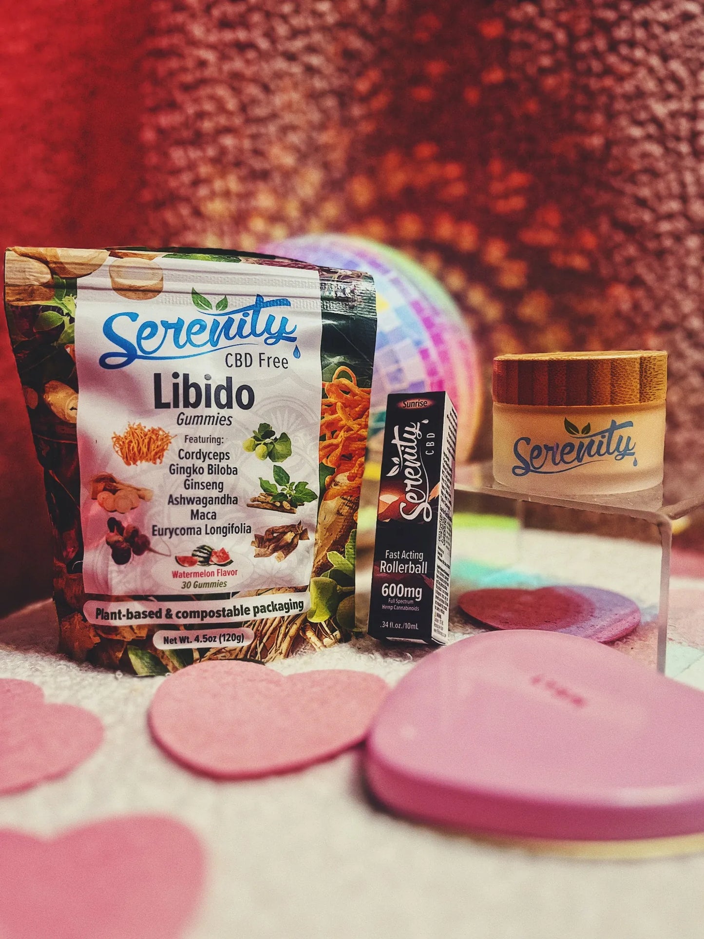 Serenity products including a jar, packaging, and a small box on a textured surface with a pink heart.