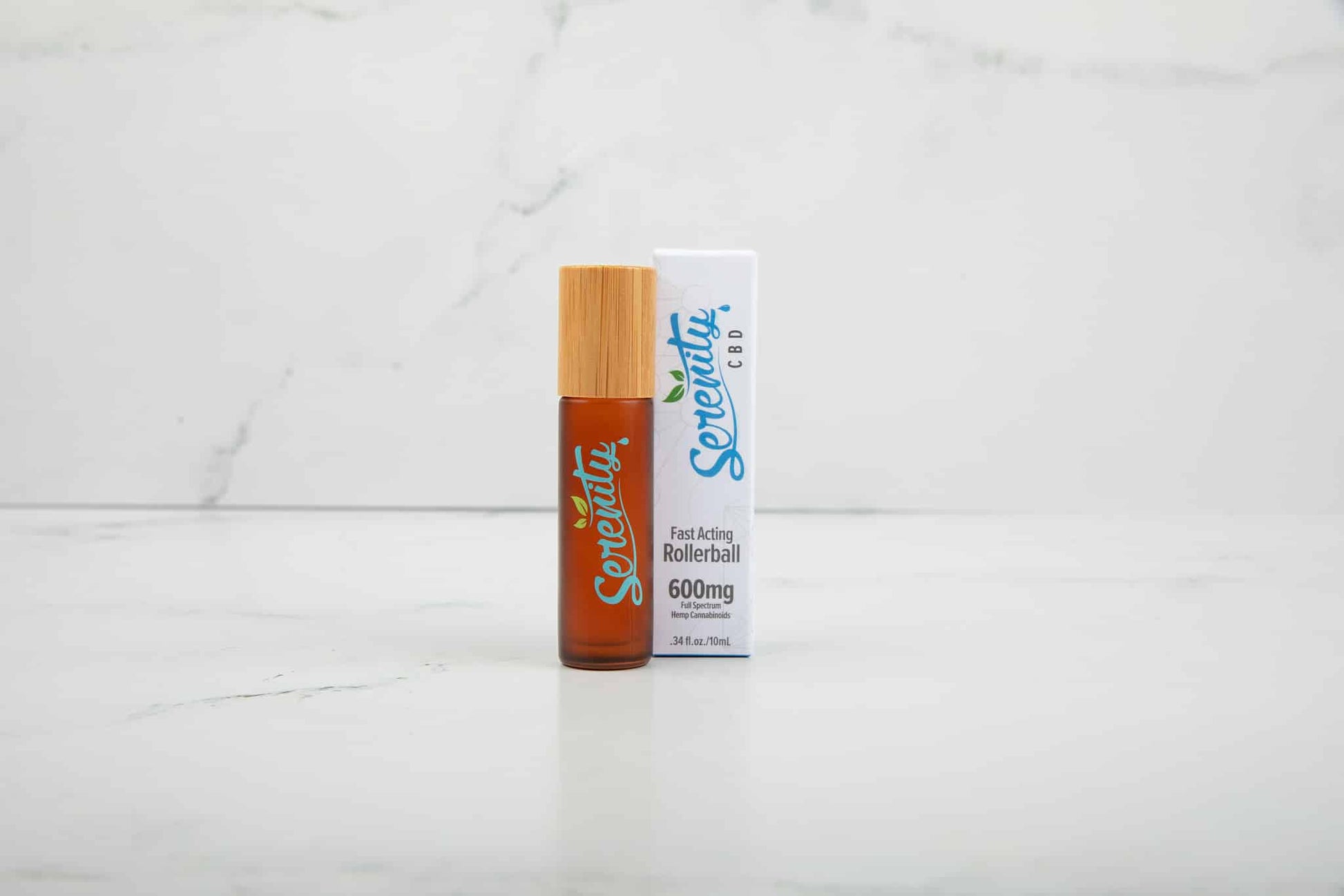 Serenity CBD Sunrise fast-acting rollerball on a white marble background—designed for convenient, on-the-go wellness and energizing relief
