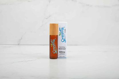 Serenity CBD Sunrise fast-acting rollerball on a white marble background—designed for convenient, on-the-go wellness and energizing relief