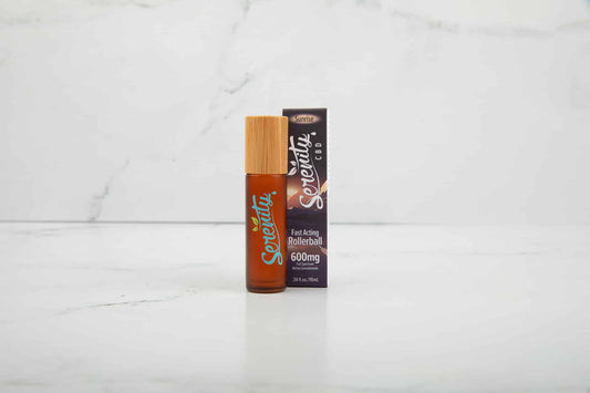 Serenity CBD Sunrise Blend Roller with packaging on a clean marble surface—crafted for energizing relief and uplifting wellness support