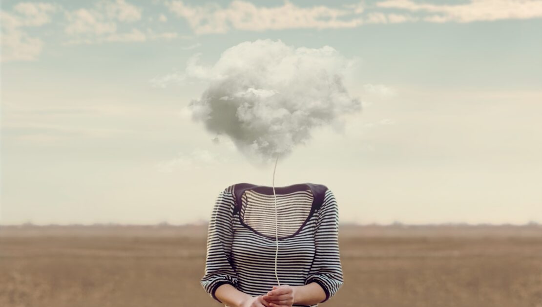 An illustration representing brain fog shows a woman's body with a cloud of fog covering her head.