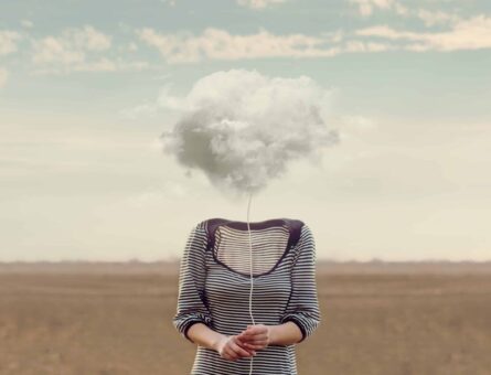 An illustration representing brain fog shows a woman's body with a cloud of fog covering her head.